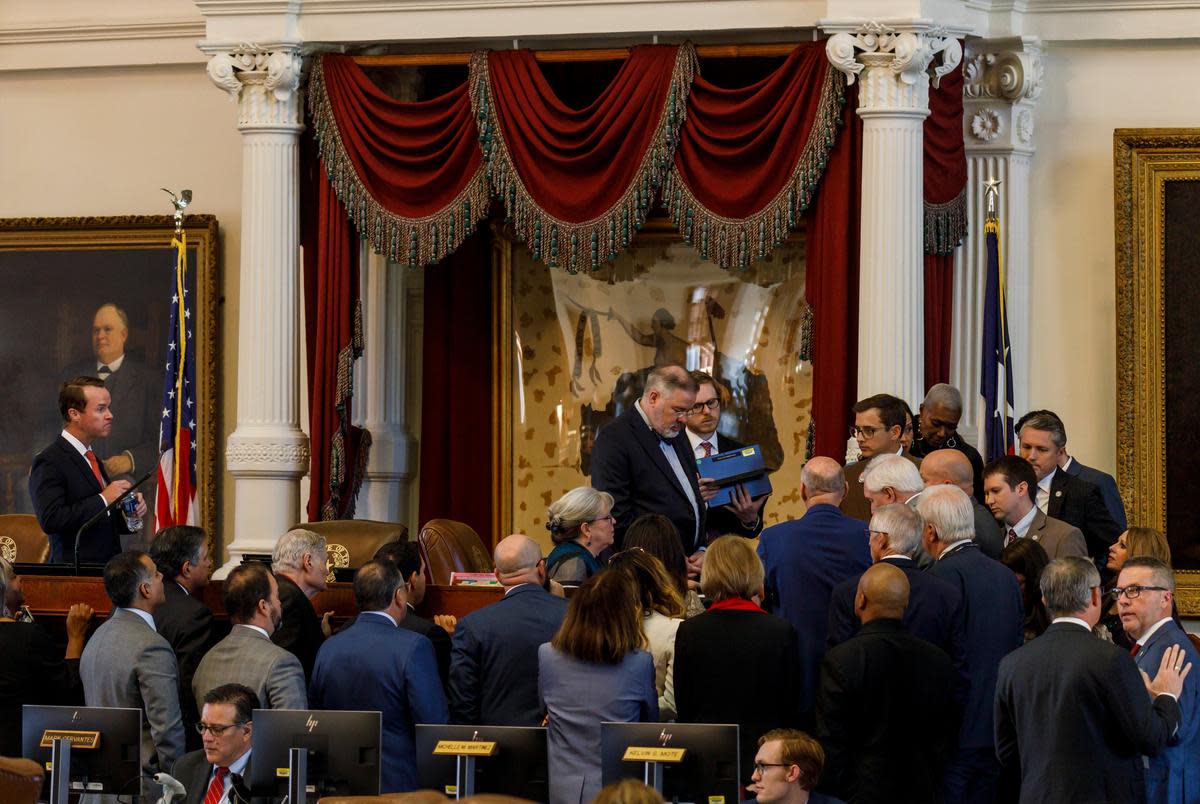 House Parliamentarian Hugh Brady, center, is joined at the dais by a group of State Representatives to discuss proceedings during a special legislative session at the state capitol in Nov. 17, 2023 in Austin.