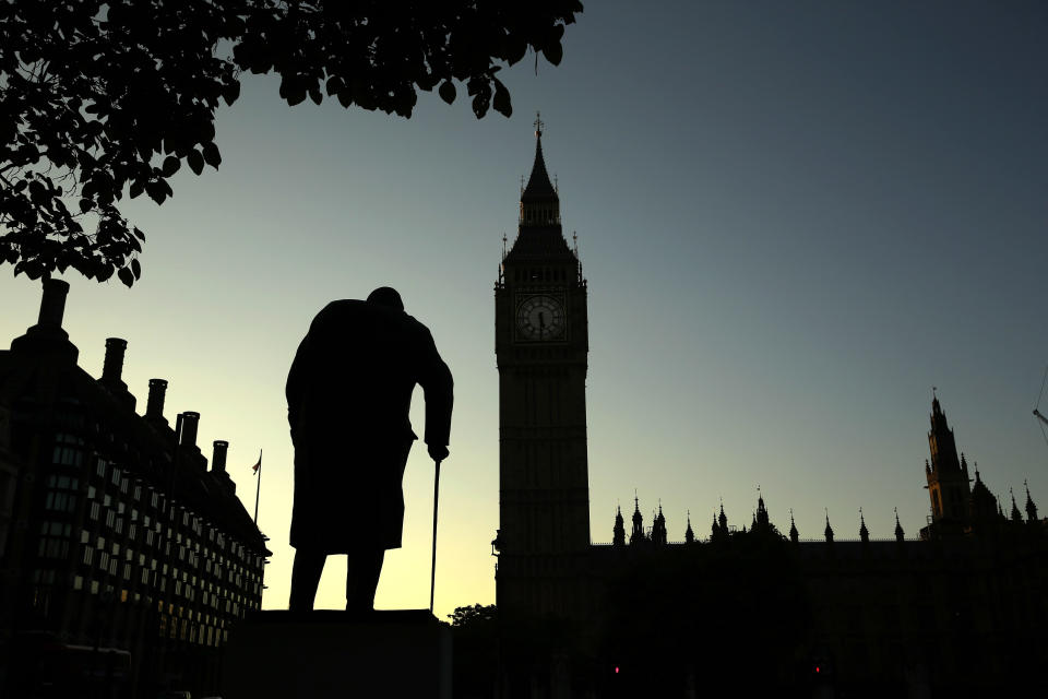 FILE - In this Friday, June 24, 2016 file photo a statue of Winston Churchill is silhouetted against the Houses of Parliament and the early morning sky in London, Friday, June 24, 2016. A day earlier, Britain had voted to leave the European Union in a referendum. On Jan. 31, 2020, Britain is scheduled to leave the EU after 47 years of membership. (AP Photo/Matt Dunham, File)