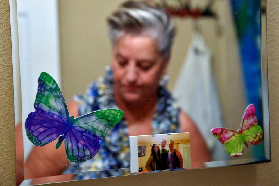 "They (butterflies) are everywhere in my home. They are a sign of renewal for me," said Yolande Kneuer, who puts on make-up in her bathroom, Tuesday, Dec. 6, 2022, in Stuart. Kneuer has recently started a balloon and flower delivery service, A Hug and a Smile, after her battle with a mental health disorder, homelessness and psychiatric hospitalizations.