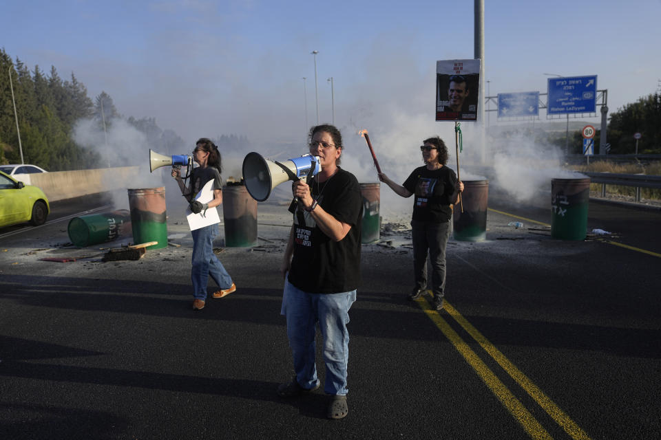 Relatives of hostages held in the Gaza Strip block Highway 1, the main route linking Tel Aviv and Jerusalem, to call for a deal to release all hostages, Friday, April 19, 2024. (AP Photo/Ohad Zwigenberg)