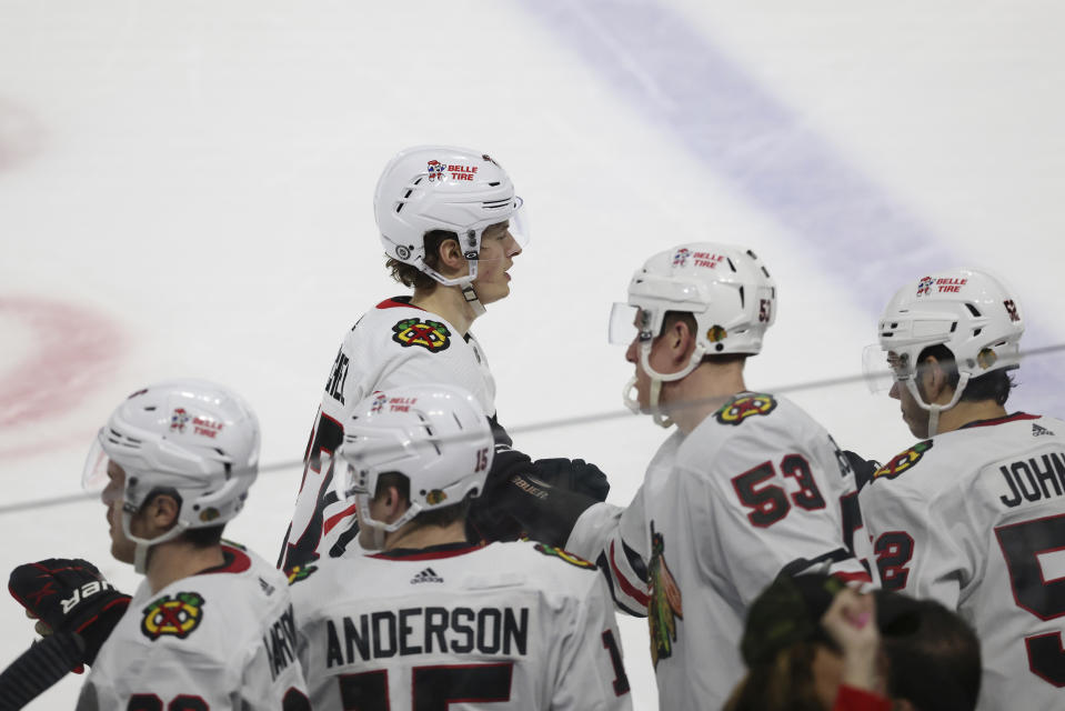 Chicago Blackhawks left wing Lukas Reichel (27) high fives teammates after scoring a goal against the Minnesota Wild during the third period of an NHL hockey game Saturday, March 25, 2023, in St. Paul, Minn. Minnesota won 3-1. (AP Photo/Stacy Bengs)