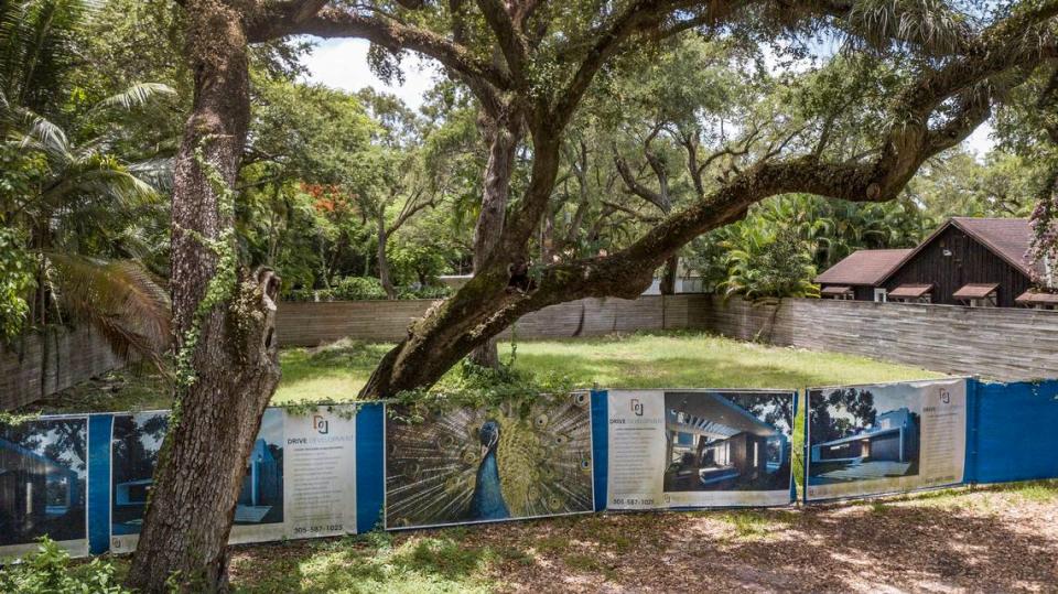 Drive Development advertises a luxury designer home along a fence in front of an empty lot on the 2000 block of Secoffee Street in Miami on Wednesday, July 6, 2022. In 2023, a court-appointed receiver took over this lot and other Coconut Grove properties owned by Doug Cox of Drive Development.