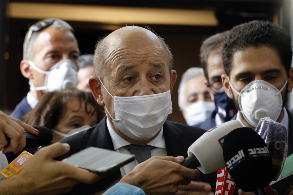 French Foreign Minister Jean-Yves Le Drian, wearing a mask to help prevent the spread of the coronavirus, speaks to journalists during his visit to the Carmel Saint Joseph school in Mechref district, south of the capital Beirut, Lebanon, Friday, July 24, 2020. Le Drian pledged on Friday €15 million ($17 million) in aid to Lebanon's schools, struggling under the weight of the country's major economic crisis. (AP Photo/Bilal Hussein)