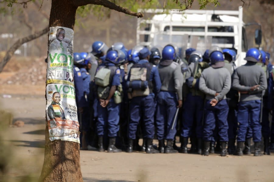 Armed riot police prepare to be deployed on the streets of Harare, Zimbabwe, Friday, Aug. 25, 2023. (AP Photo/Tsvangirayi Mukwazhi)