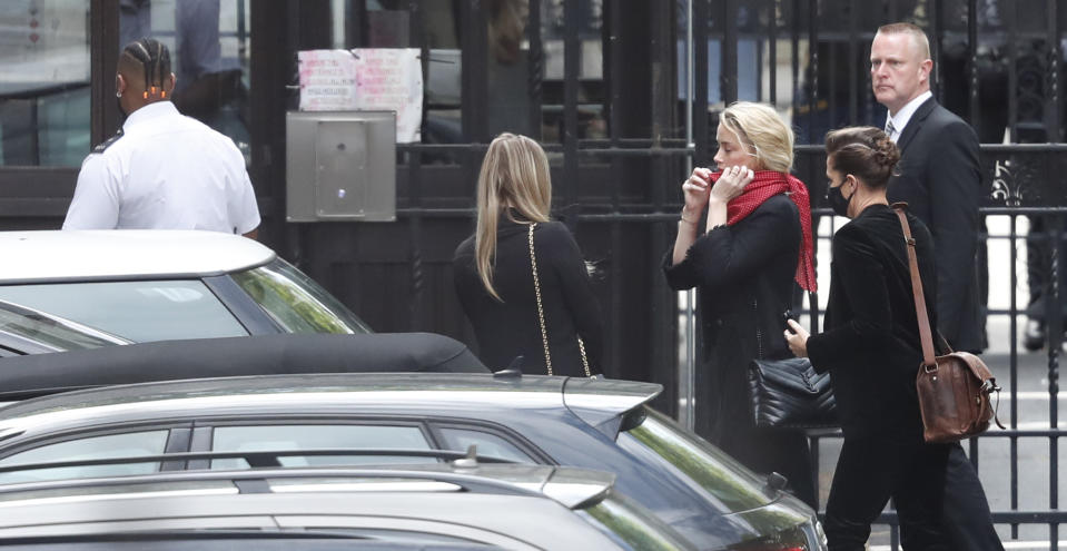 Actress Amber Heard, center, arrives at the High Court in London, Monday, July 13, 2020. Johnny Depp is expected to wrap up his evidence at his libel trial against a tabloid newspaper that accused him of abusing ex-wife Amber Heard. The Hollywood star is suing News Group Newspapers, publisher of The Sun, and the paper’s executive editor, Dan Wootton, over an April 2018 article that called him a “wife-beater. (AP Photo/Alastair Grant)