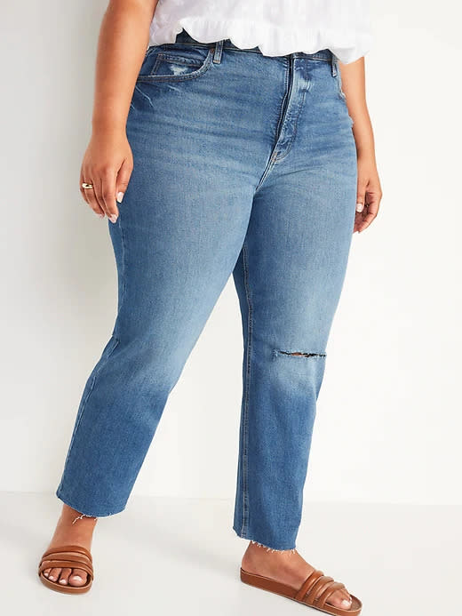 Model wears Extra High-Waisted Sky Hi Straight Button-Fly Ripped Jeans in medium blue. Image via Old Navy.