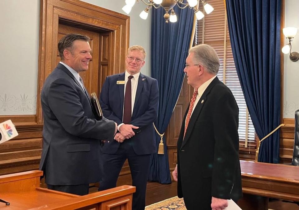 Kansas Attorney General Kris Kobach (left) speaks with Kansas Bureau of Investigation executive officer Bob Stuart (middle) and Sen. Mike Thompson (right) ahead of a press conference.