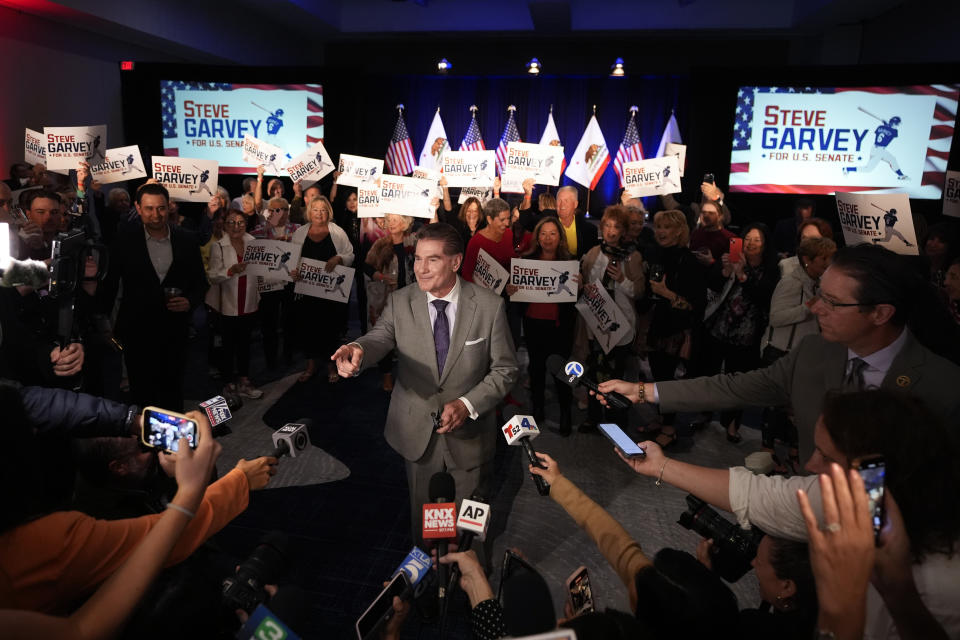 Republican U.S. Senate candidate Steve Garvey talks to reporters in front of supporters, Tuesday, March 5, 2024, in Palm Desert, Calif. (AP Photo/Gregory Bull)