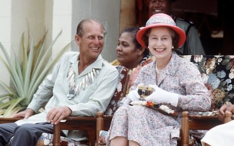 The Queen and Prince Philip share a joke during a visit to Tuvalu in 1982 - Credit:  Tim Graham