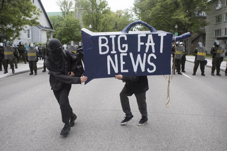 <p>Protesters run past a line of police during an anti-G7 demonstration in Quebec City on June 7, 2018, ahead of the start of the G7 summit. (Chris Young/The Canadian Press via AP) </p>