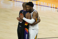 Phoenix Suns guard Chris Paul and Utah Jazz guard Donovan Mitchell, right, embrace after an NBA basketball game, Wednesday, April 7, 2021, in Phoenix. The Suns won 117-113 in overtime. (AP Photo/Matt York)