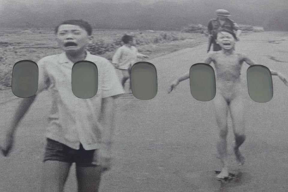 Kim Phuc waves through a window plane of a humanitarian flight transporting refugees fleeing the war in Ukraine to Canada, from Frederic Chopin Airport in Warsaw, Poland, Monday, July 4, 2022. Phuc, the girl in the famous 1972 Vietnam napalm attack photo, escorted 236 refugees from the war in Ukraine on a flight from Warsaw to Canada. Phuc's iconic Associated Press photo in which she runs with her napalm-scalded body exposed, was etched on the private NGO plane that is flying the refugees to the city of Regina, the capital of the Canadian province of Saskatchewan. (AP Photo/Michal Dyjuk)