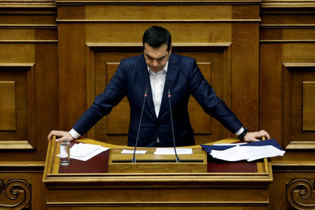 FILE PHOTO: Greek Prime Minister Alexis Tsipras pauses as he addresses lawmakers during a parliamentary session before a vote on an accord between Greece and Macedonia changing the former Yugoslav republic's name in Athens, Greece, January 24, 2019. REUTERS/Alkis Konstantinidis/File Photo