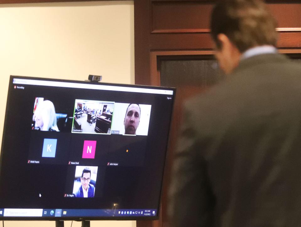 Prosecutor Andrew Urbanak questions Dr. Graham Danzer on a Zoom call, Thursday, Nov. 2, 2023, during a competency hearing for Jean Macean, the man accused of killing two people during Bike Week 2022, in Judge Elizabeth Blackburn's courtroom at the S. James Foxman Justice Center in Daytona Beach.