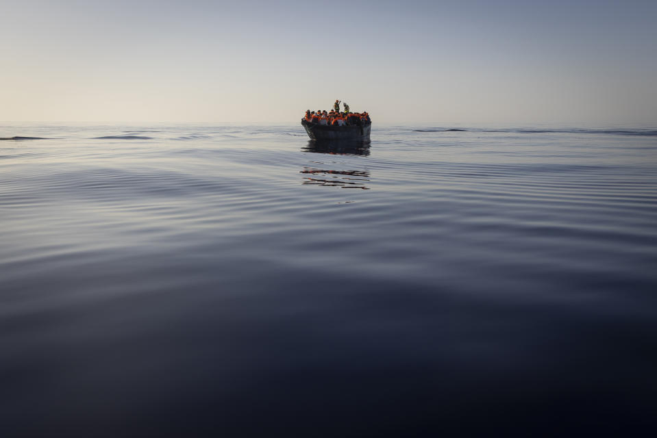 FILE - Migrants with life jackets provided by volunteers of the Ocean Viking, a migrant search and rescue ship run by NGOs SOS Mediterranee and the International Federation of Red Cross (IFCR), still sail in a wooden boat as they are being rescued, Aug. 27, 2022, in the Mediterranean sea. The back-to-back shipwrecks of migrant boats off Greece that left at least 22 people dead this week has once again put the spotlight on the dangers of the Mediterranean migration route to Europe. (AP Photo/Jeremias Gonzalez, file)