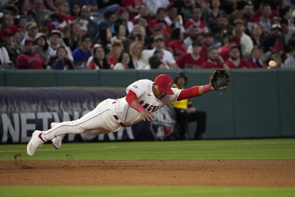 Los Angeles Angels third baseman Eduardo Escobar can't get to a ball hit for a single by Chicago White Sox's Luis Robert Jr. during the sixth inning of a baseball game Wednesday, June 28, 2023, in Anaheim, Calif. (AP Photo/Mark J. Terrill)