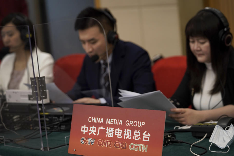 China's state broadcaster CCTV news broadcasters read news at a media center during a news conference on the eve of the annual legislature opening session in Beijing on March 4, 2021. Israel's Embassy in China is protesting what it describes as "blatant anti-Semitism" on a program run by the overseas channel of state broadcaster CCTV discussing the ongoing violence in Gaza and elsewhere. (AP Photo/Andy Wong)