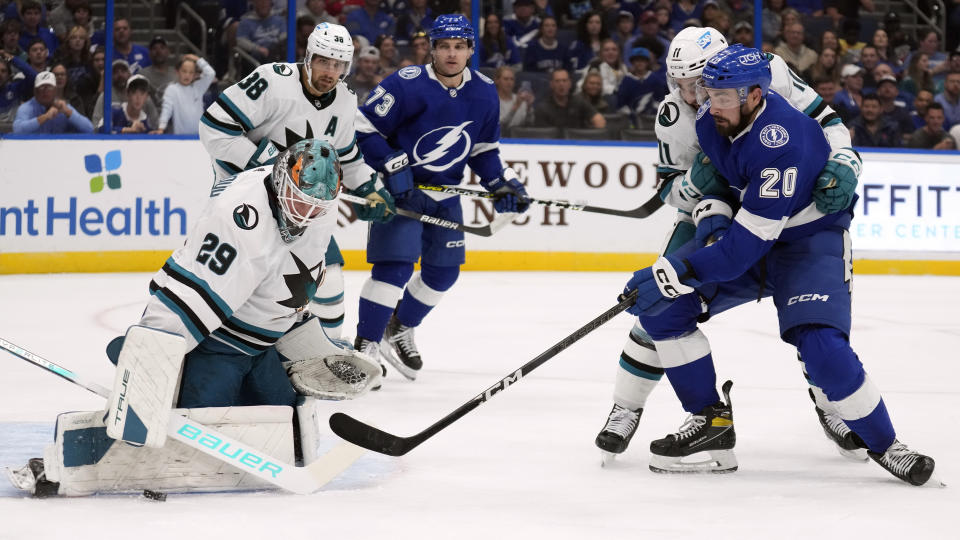 Tampa Bay Lightning left wing Nick Paul (20) shoots on San Jose Sharks goaltender Mackenzie Blackwood (29) during the second period of an NHL hockey game Thursday, Oct. 26, 2023, in Tampa, Fla. (AP Photo/Chris O'Meara)