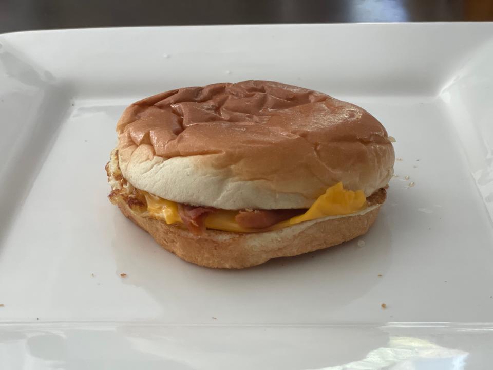 Sandwich of bacon, egg, and cheese on a squashed bun