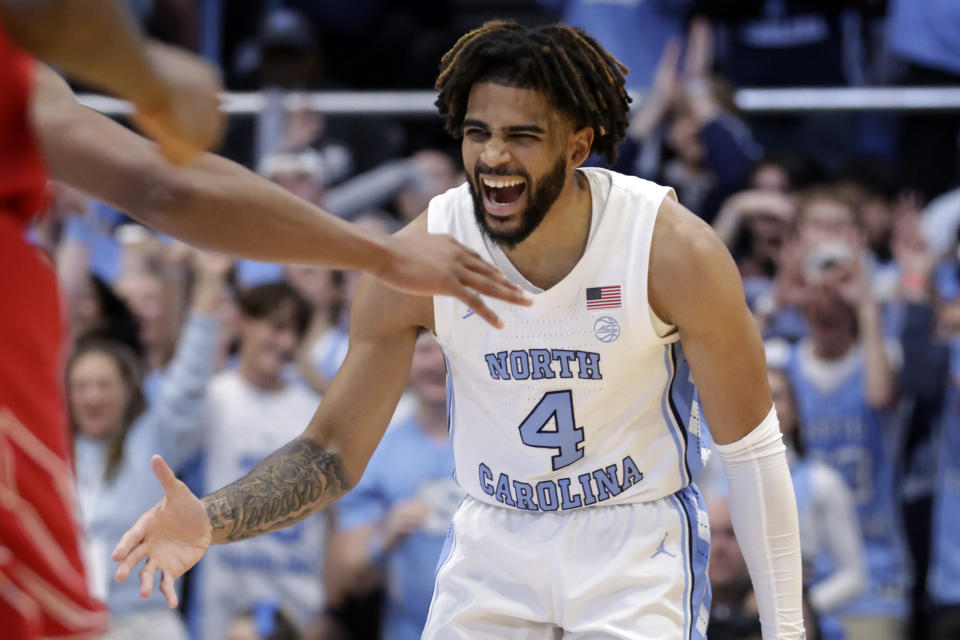 North Carolina guard RJ Davis (4) celebrates after hitting a 3-pointer against Louisville during the first half of an NCAA college basketball game Wednesday, Jan. 17, 2024, in Chapel Hill, N.C. (AP Photo/Chris Seward)