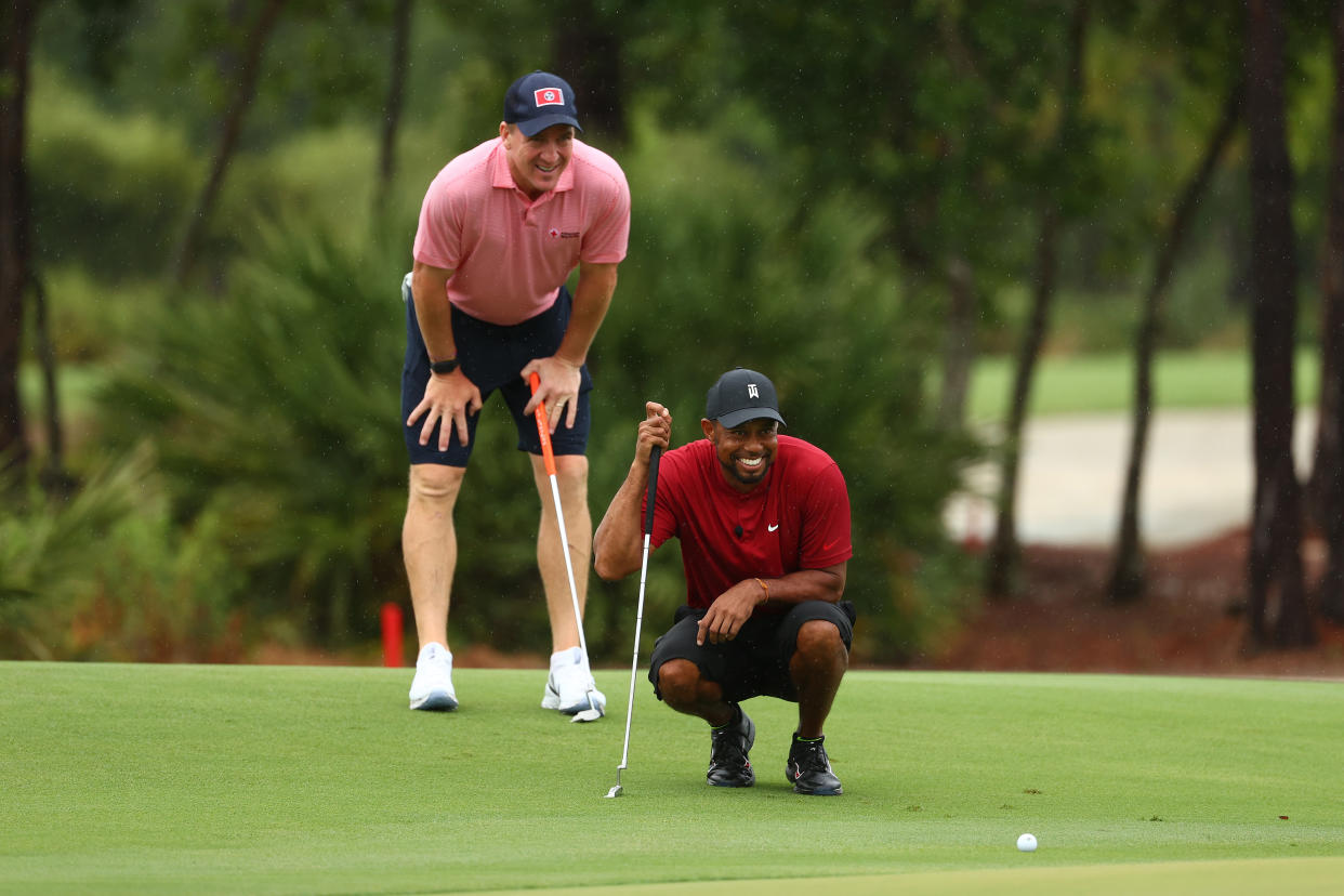 Tiger Woods and Peyton Manning read a putt on the sixth green during "The Match: Champions For Charity" at Medalist Golf Club on Sunday in Hobe Sound, Florida. (Mike Ehrmann/Getty Images for The Match)