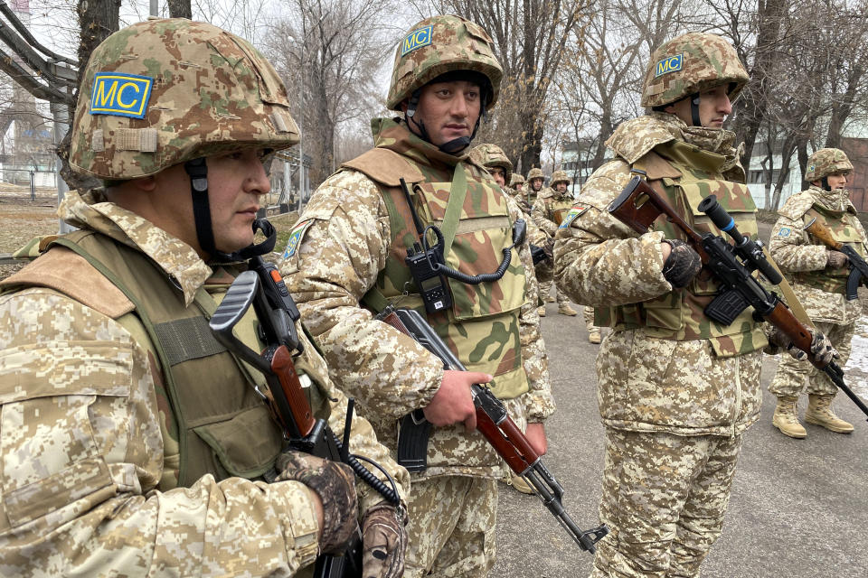 In this handout photo released by Russian Defense Ministry Press Service, Collective Security Treaty Organization peacekeepers guard an area in Almaty, Kazakhstan, Tuesday, Jan. 11, 2022. The president of Kazakhstan has announced that a Russia-led security alliance will start pulling out its troops from the country in two days after completing its mission. The mostly Russian troops were deployed to Kazakhstan last week by the Collective Security Treaty Organization, an alliance of six former Soviet states, at the president's request amid unprecedented public unrest. (Russian Defense Ministry Press Service via AP)