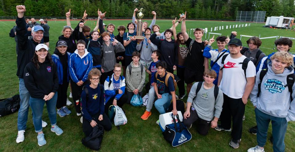 The Winnacunnet High School boys track team celebrate their first-place win at Friday's Seacoast Track Championship meet at Exeter High School.