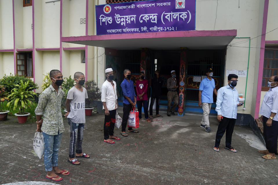 In this May 20, 2020, photo, provided by UNICEF, Mohammed Rakib, 15, who was accused of beating a man and sent to an overcrowded detention center, stands with other inmates before being released in Tongi, on the outskirts of Dhaka, Bangladesh. Authorities in Bangladesh have been releasing hundreds of children suspected of committing mostly petty crimes as they try to keep the coronavirus from spreading in overcrowded detention centers, officials said Friday. The orders for their release on bail came from virtual courts set up by the country's Supreme Court with the help of UNICEF, officials said. "It feels great to be freed and get united with my parents," Rakib told The Associated Press on Friday. "I am very happy. I have suffered in the jail a lot. That's a bad place." (UNICEF via AP)