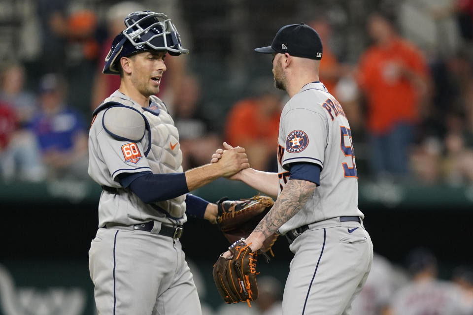 Houston Astros closer Ryan Pressly (55) is congratulated by catcher Jason Castro after the team's win over the Texas Rangers in a baseball game in Arlington, Texas, Tuesday, June 14, 2022. (AP Photo/LM Otero)