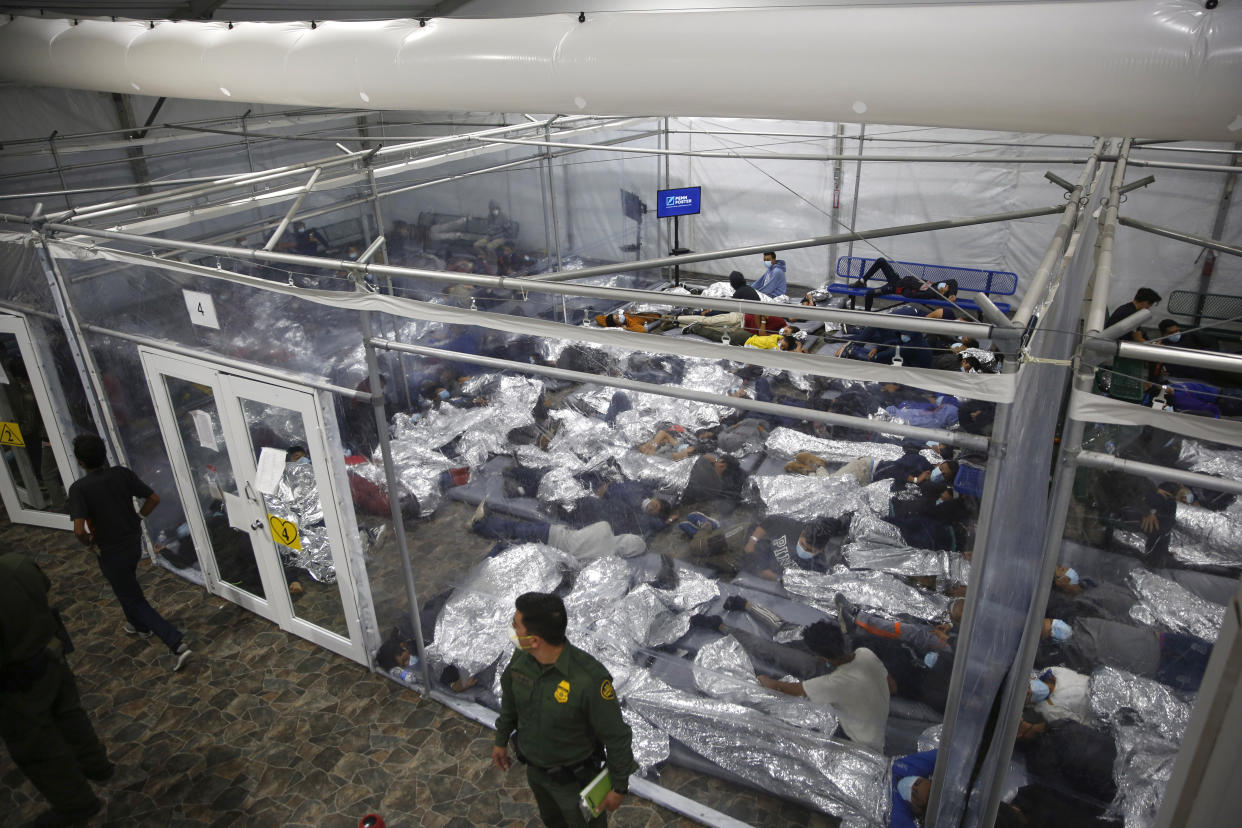 FILE - Children lie inside a pod at the main detention center for unaccompanied children in the Rio Grande Valley run by U.S. Customs and Border Protection (CBP), in Donna, Texas, March 30, 2021. (AP Photo/Dario Lopez-Mills, Pool, File)