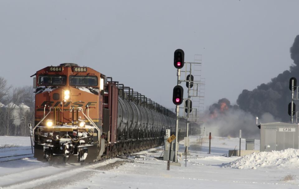 A plume of smoke rises from scene of a derailed train near Casselton, North Dakota