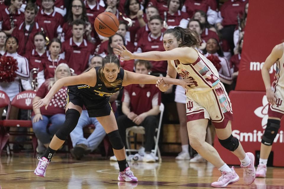 Indiana's Mackenzie Holmes (54) deflects the ball from Michigan's Emily Kiser during the second half of an NCAA college basketball game Thursday, Feb. 16, 2023, in Bloomington, Ind. (AP Photo/Darron Cummings)