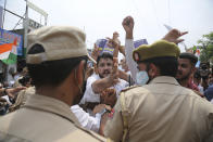 Members of National Students' Union of India scuffle with police during protest marking the second anniversary of Indian government scrapping Kashmir’s semi- autonomy in Jammu, India, Thursday, Aug. 5, 2021. On Aug. 5, 2019, Indian government passed legislation in Parliament that stripped Jammu and Kashmir’s statehood, scrapped its separate constitution and removed inherited protections on land and jobs. (AP Photo/Channi Anand)
