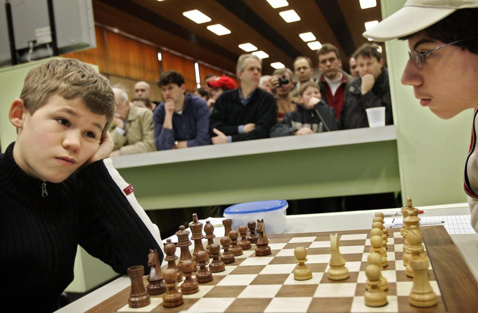 Swedish Magnus Carlsen,13, plays chess against Costa Rican Alejandro Ramirez, 15, on the first day of the Corus Chess Tournament in January 2005.