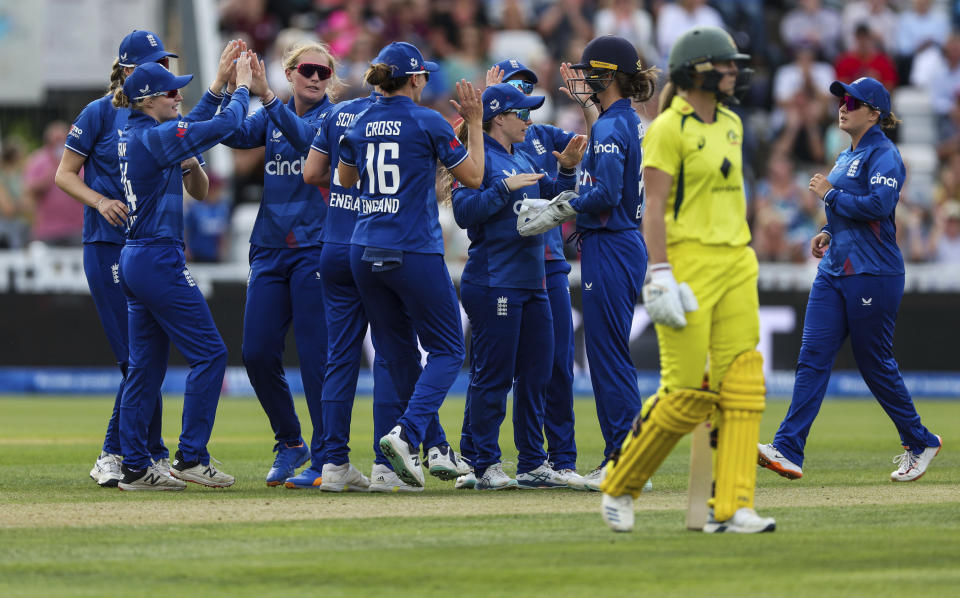 England's Sophie Ecclestone, left, celebrates with teammates after taking the wicket of Australia's Tahlia McGrath during the third one day international of the Women's Ashes Series at the at Cooper Associates County Ground, Taunton, England, Tuesday July 18, 2023. (Steven Paston/PA via AP)