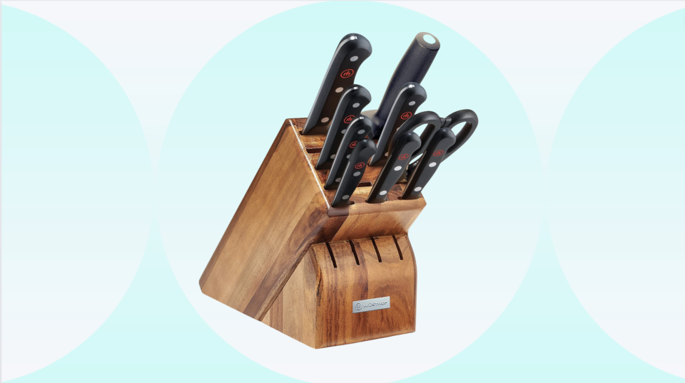 the Wusthof knife set in a wooden block on a teal and white background