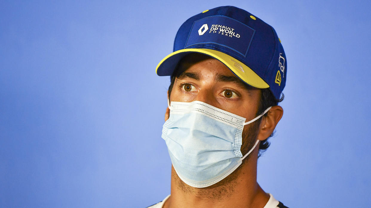 Daniel Ricciardo is pictured wearing a face mask during a press conference at the Austrian Grand Prix.