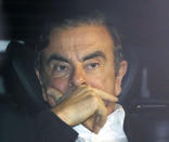 FILE - In this March 6, 2019, file photo, former Nissan chairman Carlos Ghosn rides in a car from a building in Tokyo, after posting 1 billion yen ($8.9 million) in bail once an appeal by prosecutors against his release was rejected. Nissan is seeing sales and profits tumble, as its once revered former chairman, Carlos Ghosn, awaits trial on charges of financial misconduct. The Japanese automaker says it is beefing up corporate governance and sticking with its alliance with French partner Renault SA. (Takuya Inaba/Kyodo News via AP)