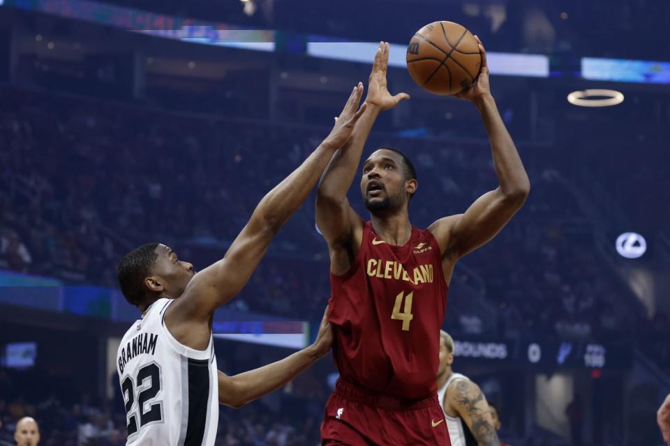 Cleveland Cavaliers forward Evan Mobley shoots over San Antonio Spurs guard Malaki Branham.