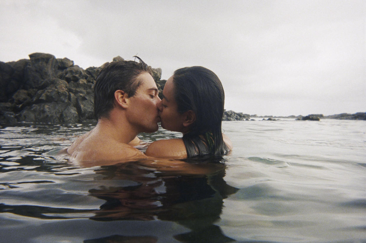 A couple kiss in romantic way in water