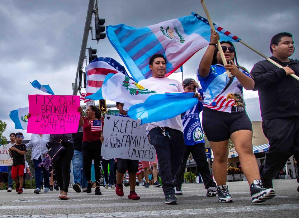 Members of an immigrant rights-group march west along Lake Avenue to City Hall during a rally in Lake Worth Beach to protest Florida's new (SB) 1718 immigration-related legislation Sunday,