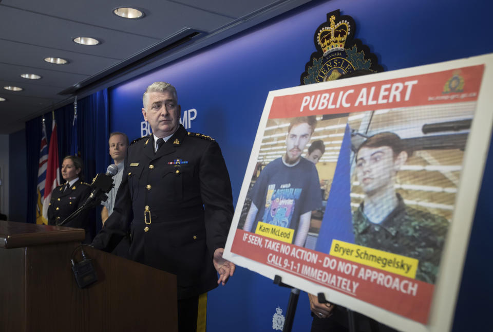 Photo shows Royal Canadian Mounted Police officers standing next to security camera images recorded in Saskatchewan of Kam McLeod, 19, and Bryer Schmegelsky, 18.