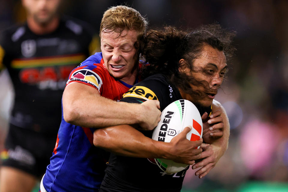 Seen here, Penrith's Jarome Luai is tackled by Newcastle fullback Lachlan Miller in the NRL round seven clash. 