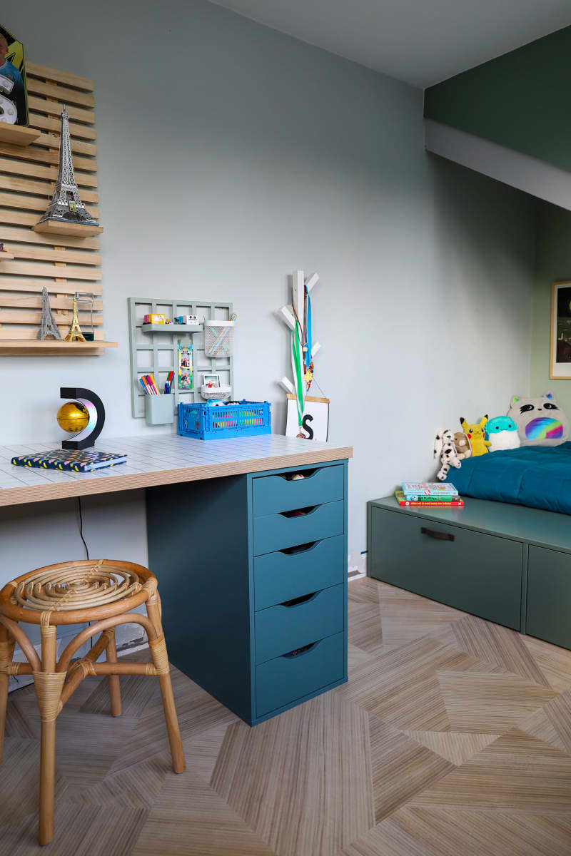 Desktop with file cabinet in child's neutral bedroom.