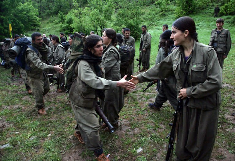 Kurdistan Workers' Party (PKK) fighters greet their comrades as they arrive in Dohuk, northern Iraq, on May 14, 2013. The first group of Kurdish fighters pulling out of Turkey under the terms of a truce arrived in the autonomous Kurdish region of neighbouring Iraq to handshakes and embraces after a gruelling week-long journey