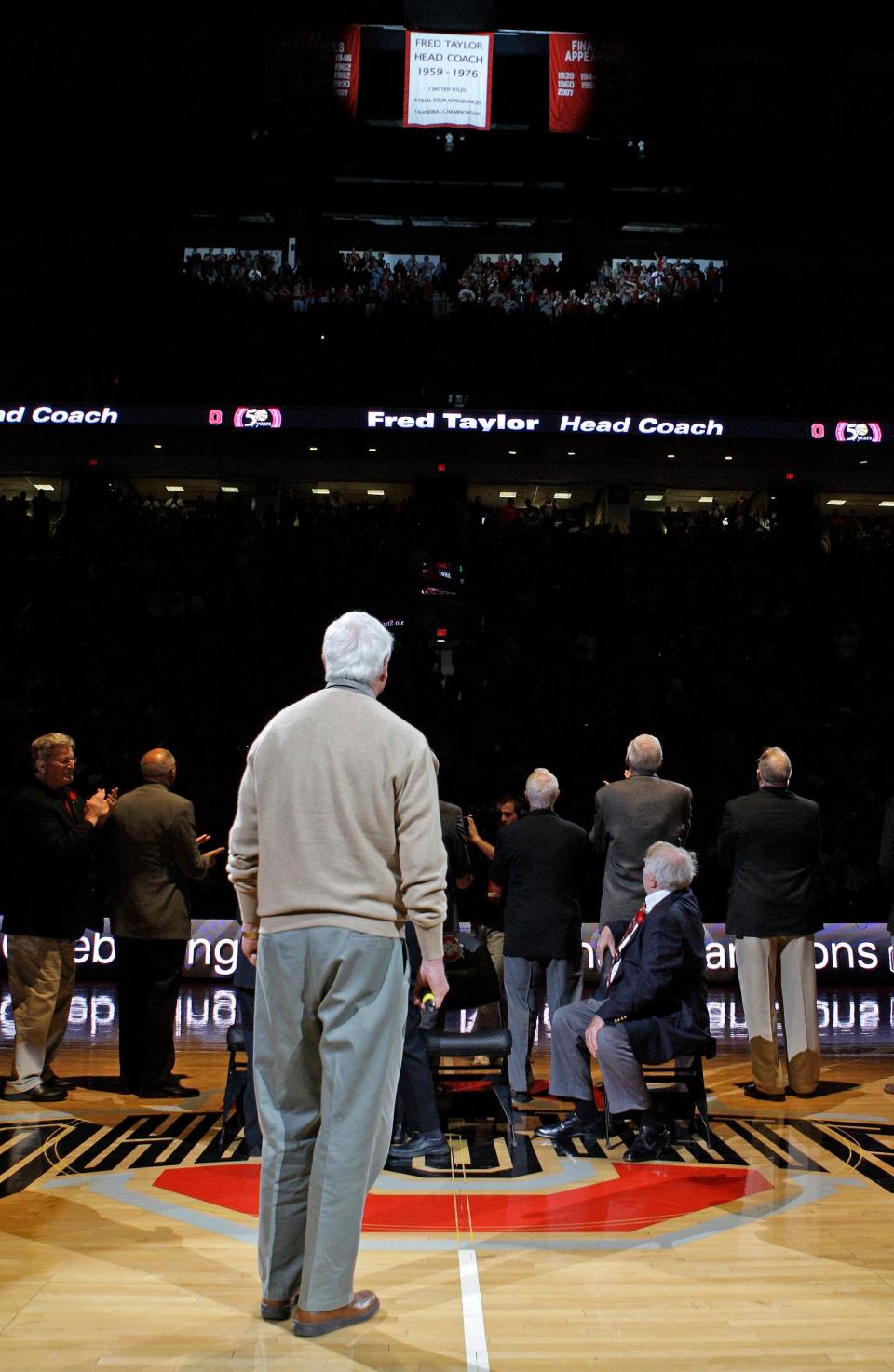Former college basketball coach Bob Knight, front, along with other players from Ohio State's 1960 national championship team watch the unveiling of a banner during a halftime ceremony honoring coach Fred Taylor and the team Sunday, Jan. 31, 2010, in Columbus, Ohio. Some of the most notable players from the 1960 championship team include Jerry Lucas and John Havlicek, named two of the top 50 NBA greatest players in history, and Bob Knight, college basketball's winningest coach. (AP Photo/Jay LaPrete)