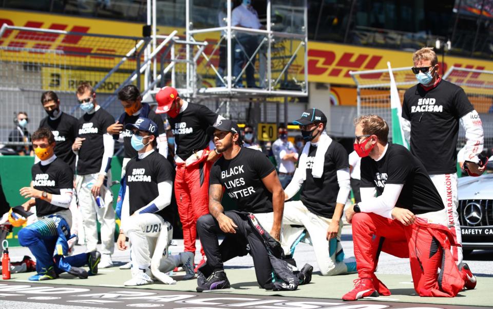Lewis Hamilton of Great Britain and Mercedes GP, Pierre Gasly of France and Scuderia AlphaTauri and some of the F1 drivers take a knee on the grid in support of the Black Lives Matter movement ahead of the Formula One Grand Prix of Austria at Red Bull Ring on July 05, 2020 in Spielberg, Austria. - GETTY IMAGES