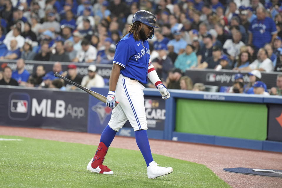 Toronto Blue Jays' Vladimir Guerrero Jr. walks back to the dugout after striking out against the Seattle Mariners during the sixth inning of Game 1 in an AL wild-card baseball playoff series in Toronto on Friday, Oct. 7, 2022. (Nathan Denette/The Canadian Press via AP)