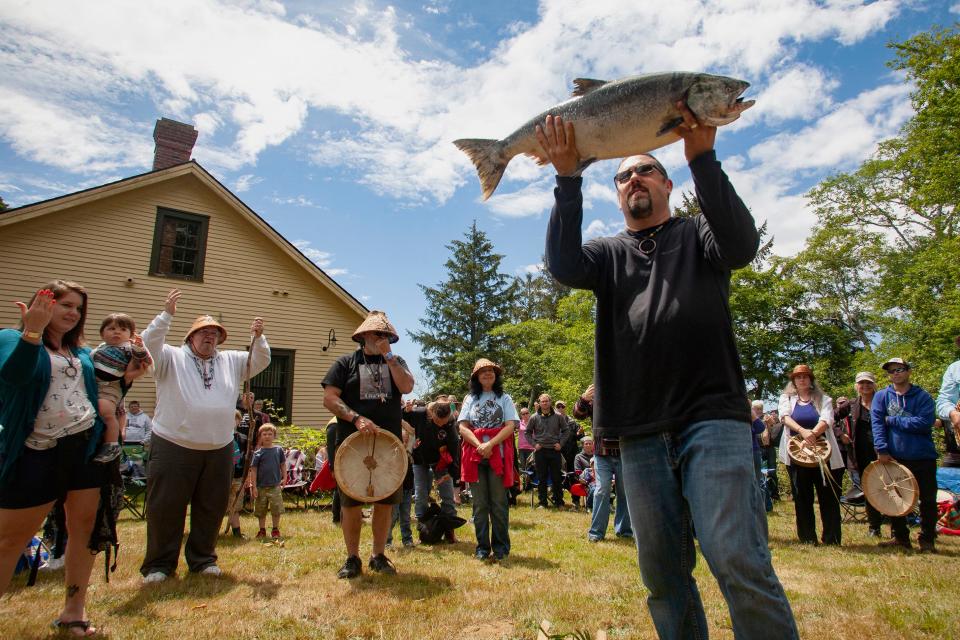 Tony Johnson holds up the First Salmon during the annual First Salmon Ceremony at Fort Columbia, Washington.