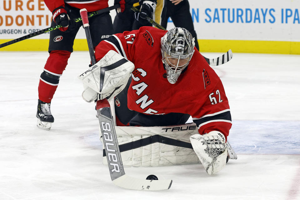 Carolina Hurricanes goaltender Pyotr Kochetkov (52) gathers the puck against the Pittsburgh Penguins during the first period of an NHL hockey game in Raleigh, N.C., Sunday, Dec. 18, 2022. (AP Photo/Karl B DeBlaker)